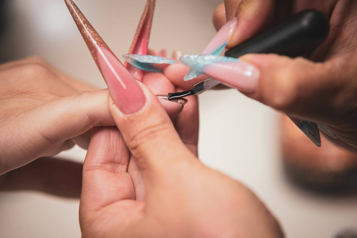 Woman sanitizing her premium nail tools after use