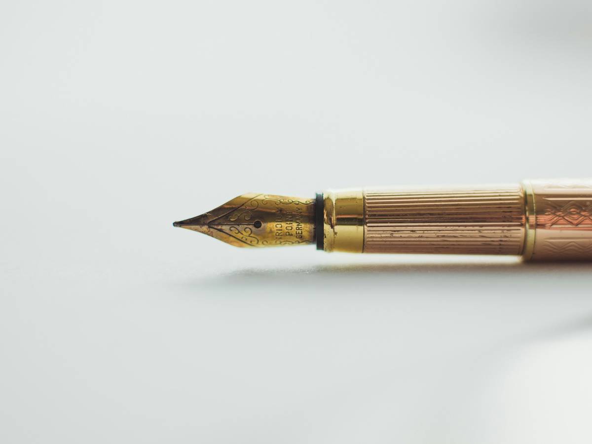 Close-up of a sleek high-quality nail pen on a white background.
