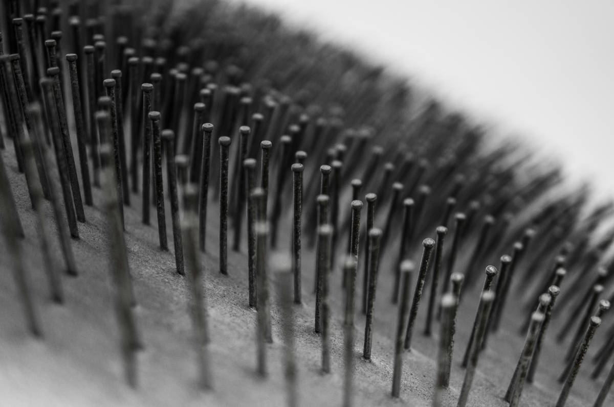 Side-by-side comparison showing frayed bristles on a cheap brush versus sleek, intact ones on a pro nail art brush.