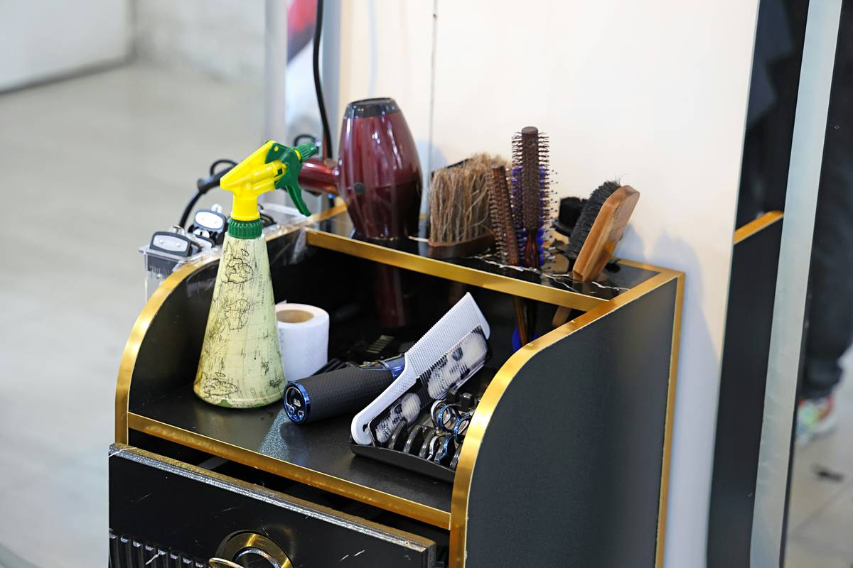Close-up image showing various nail design liner tools including brushes, pens, and striping tapes.