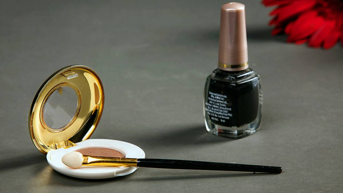 A collection of nail art tools including brushes, dotting pens, and embellishments