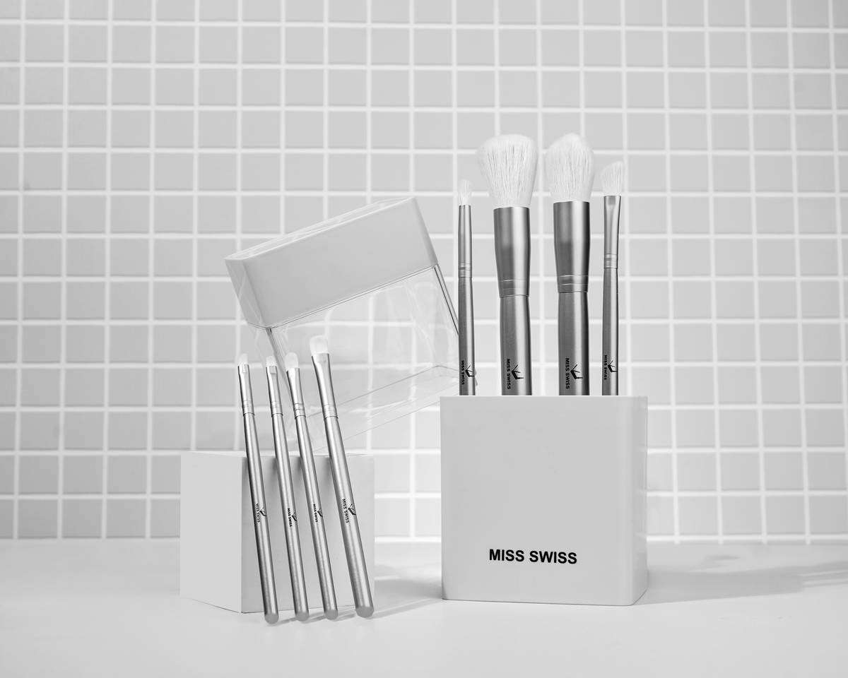 A high-quality professional nail brush set with various sizes and shapes laid out on a clean workspace