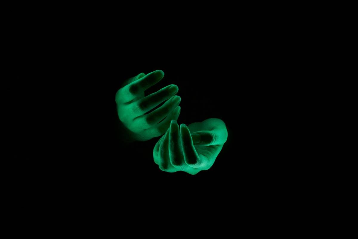 a dark room with a glowing green object in the middle of it