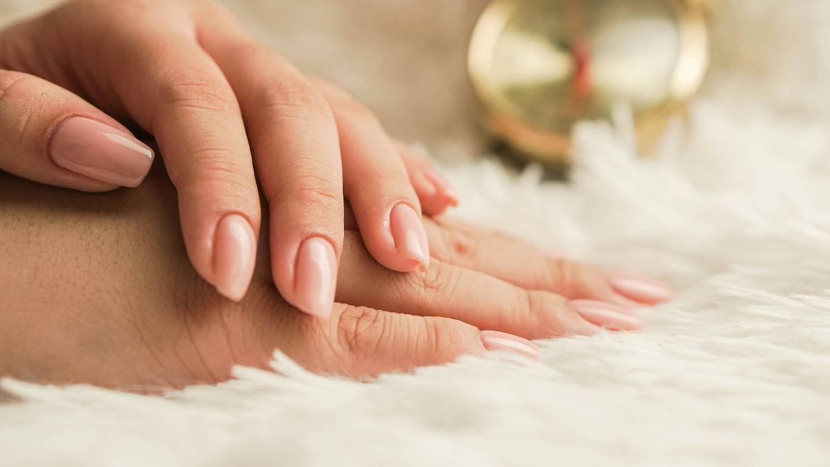 A woman posing her hands with newly polished nails.