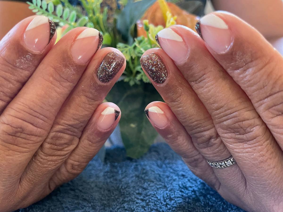 a woman's hands with a manicure and a ring