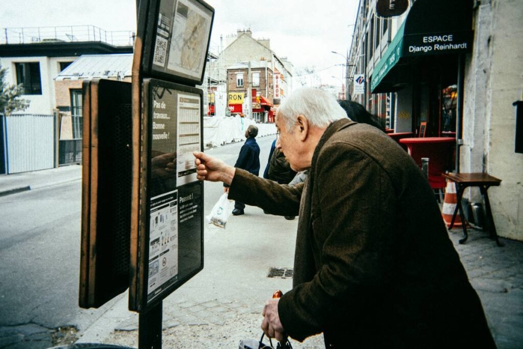 Elderly man looking at a public information board