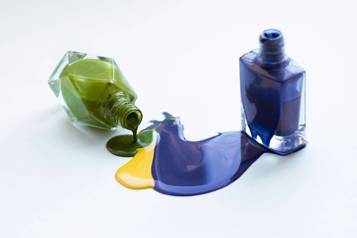 Green, yellow and purple spilled out nail polish and bottles. Don't forget to credit the author, please)