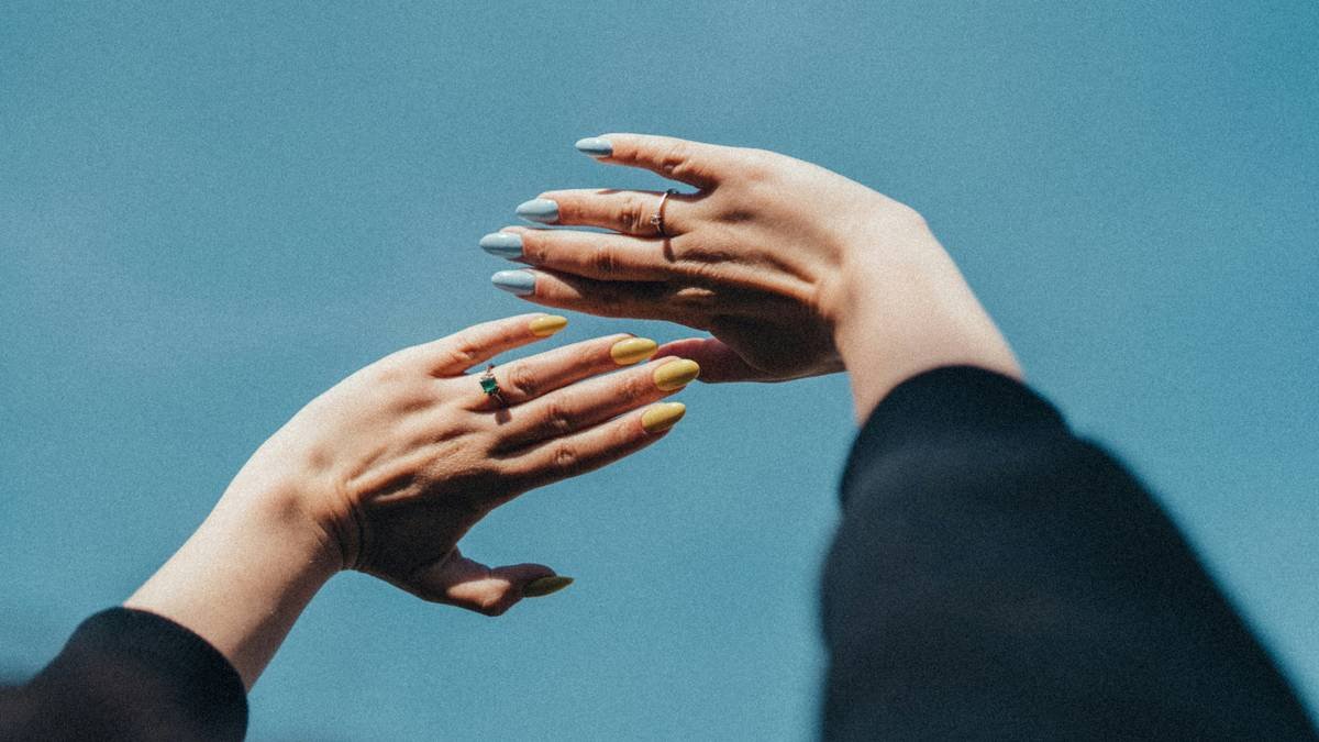 two hands reaching out towards each other